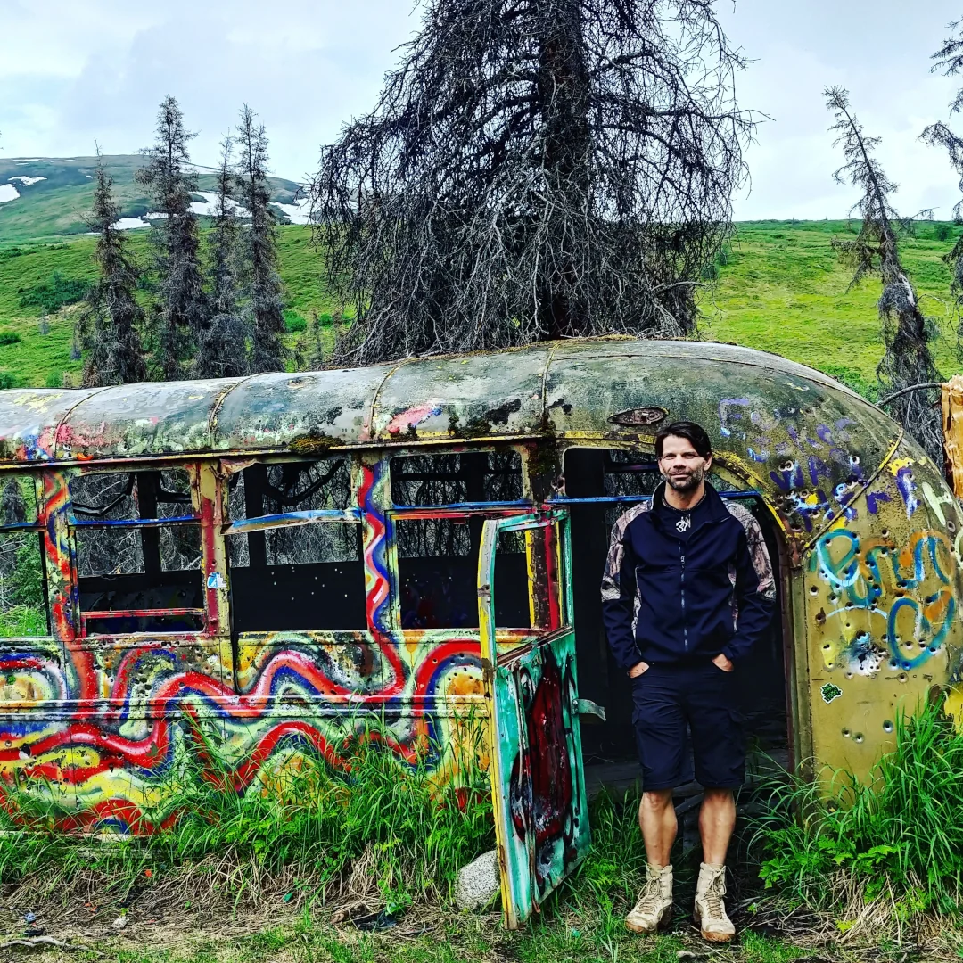 Chad Reilly in front of bus at Hatcher Pass, Alaska.