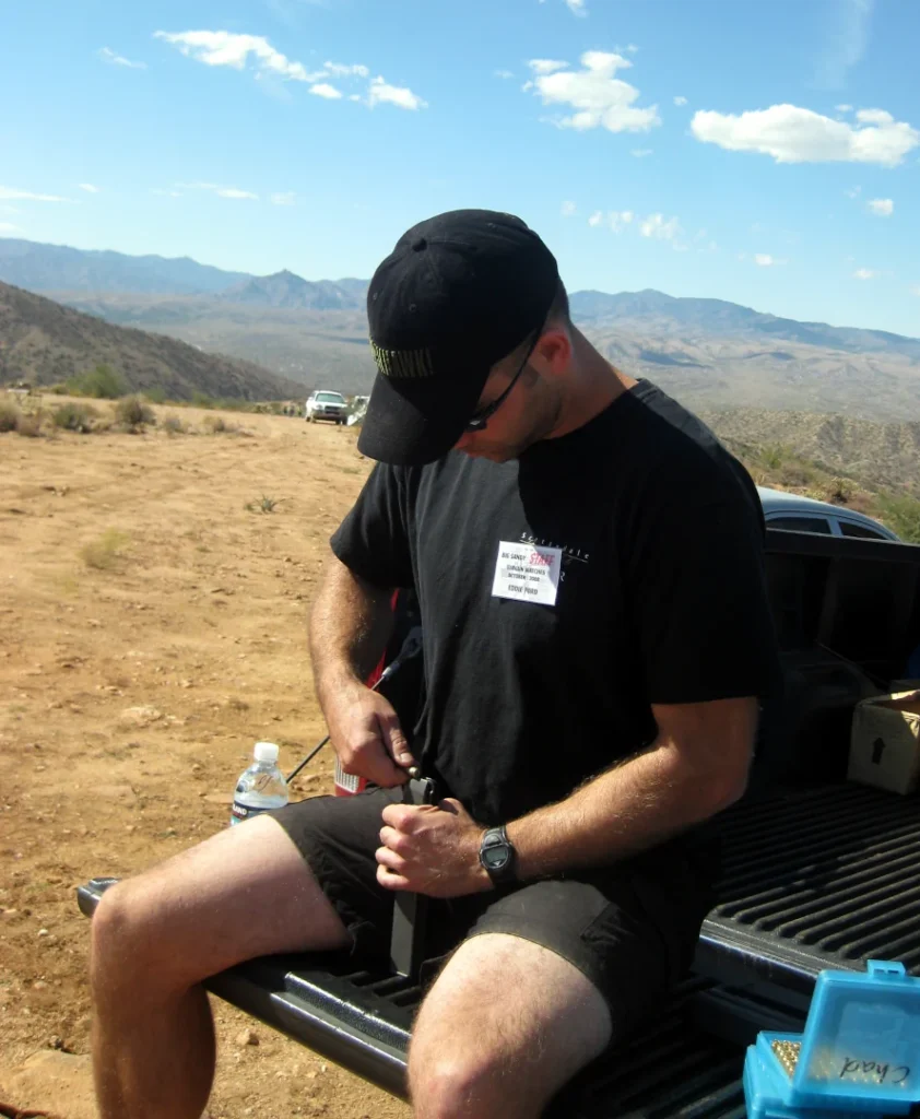 Me loading magazines on a tailgate at the Big Sandy Machine Gun Shoot.